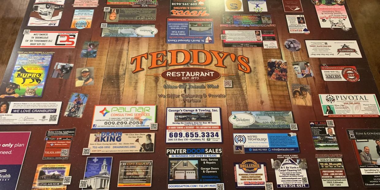 A restaurant table covered with various business cards and advertisements.