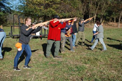 youth participants learning gun safety and proper stance with wooden guns
