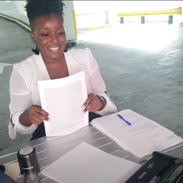 traveling mobile notary public at table in a parking garage scanning document during a mobile notary 