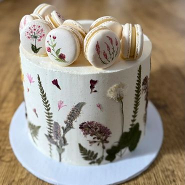 Elegant floral-themed cake with macarons.