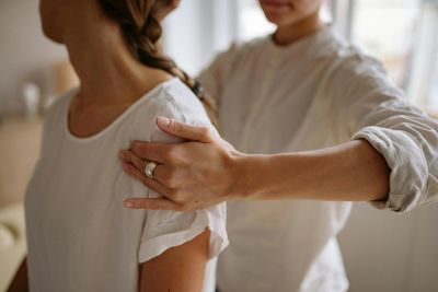 Person massaging another person's shoulder.