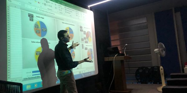 A consultant at one of the client premises explaining sales buttom line