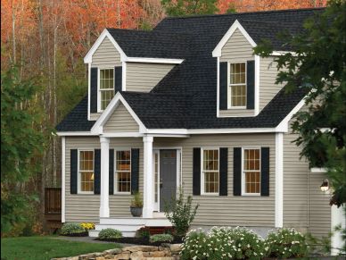 Cozy suburban house with autumn backdrop.
