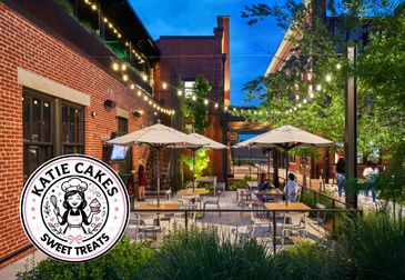 Outdoor cafe seating area with string lights.