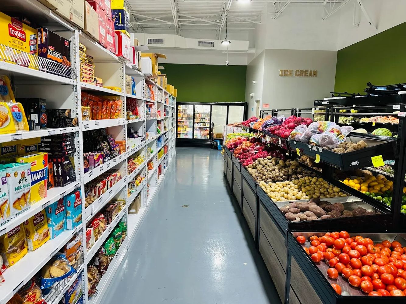 Grocery store aisle with fresh produce and packaged snacks.