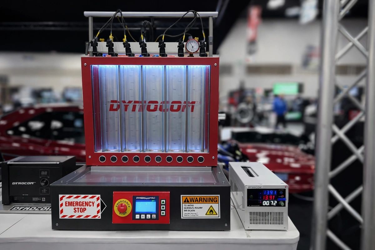 Dynocom AIC-8 injector dyno with flow tubes, controls, and test equipment.