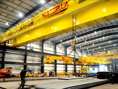 Heavy-duty crane operating in a large warehouse.