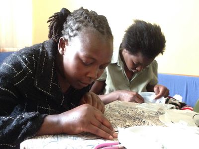 Kiberan women learning how to make jewelry
