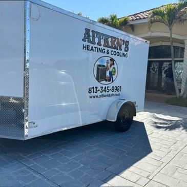 About Us ,Aitken's Heating and Cooling with their business trailer loaded with a new AC unit for ins