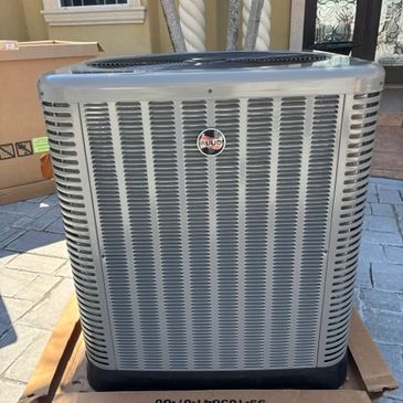 Outdoor air conditioning unit installed near a house.