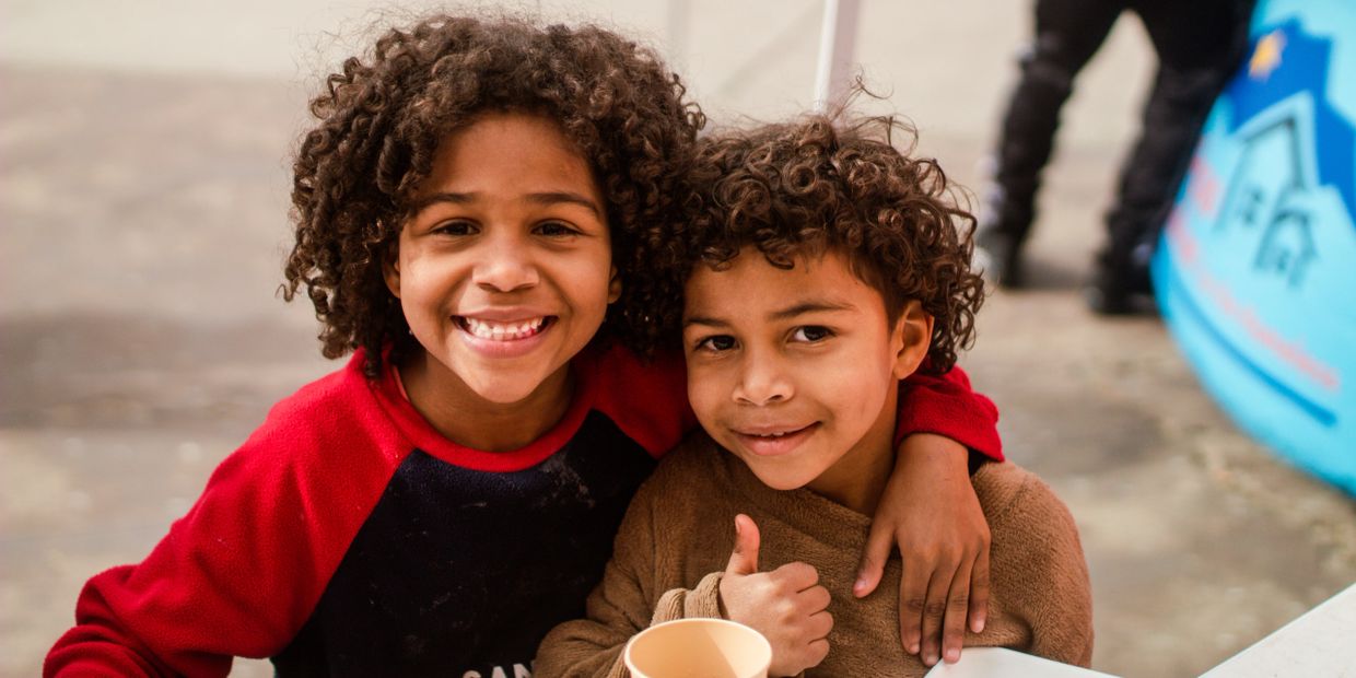 Two children smiling.