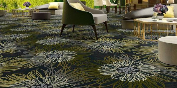 Luxurious lounge area with floral carpet and modern furniture.