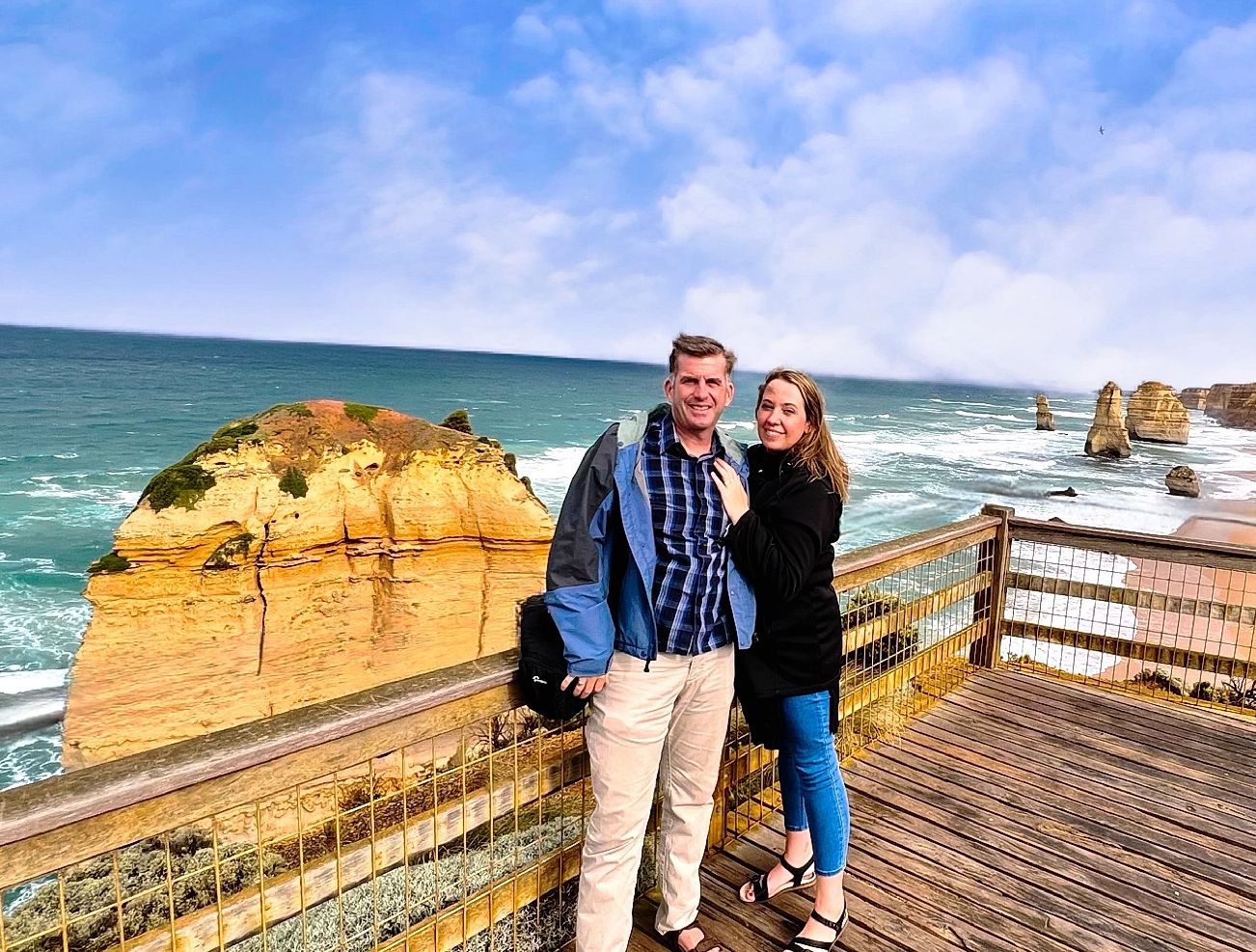 Couple overlooking the Twelve Apostles rock formations the Great Ocean Road in Victoria Australia.