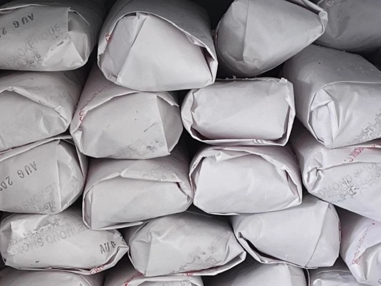 Stacked white paper-wrapped packages arranged neatly.