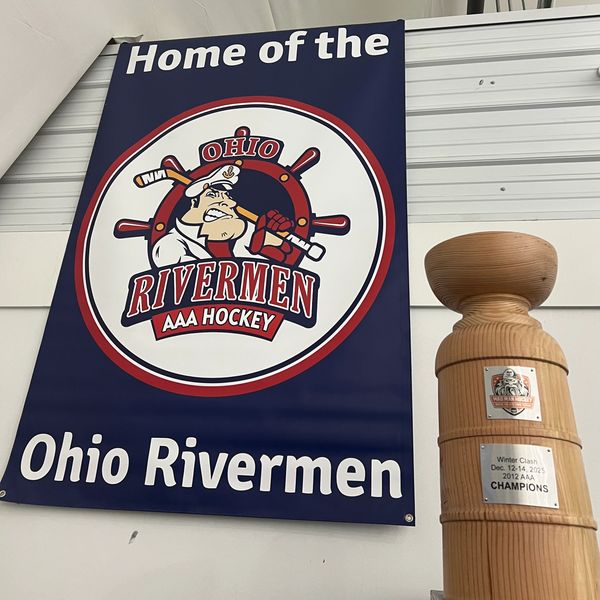 Banner and trophy celebrating Ohio Rivermen AAA Hockey team.