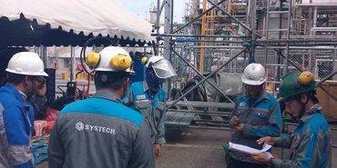 Workers having a meeting at an industrial site.