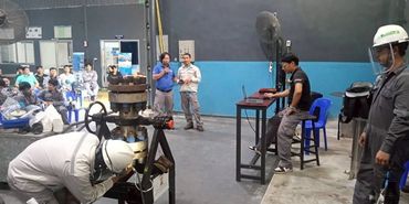 Industrial training session with workers and machinery.