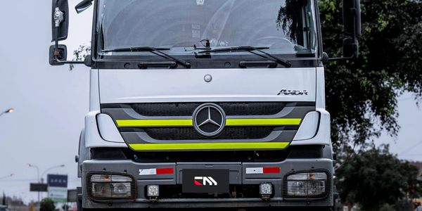 Front view of a white Mercedes-Benz Axor truck on a road.