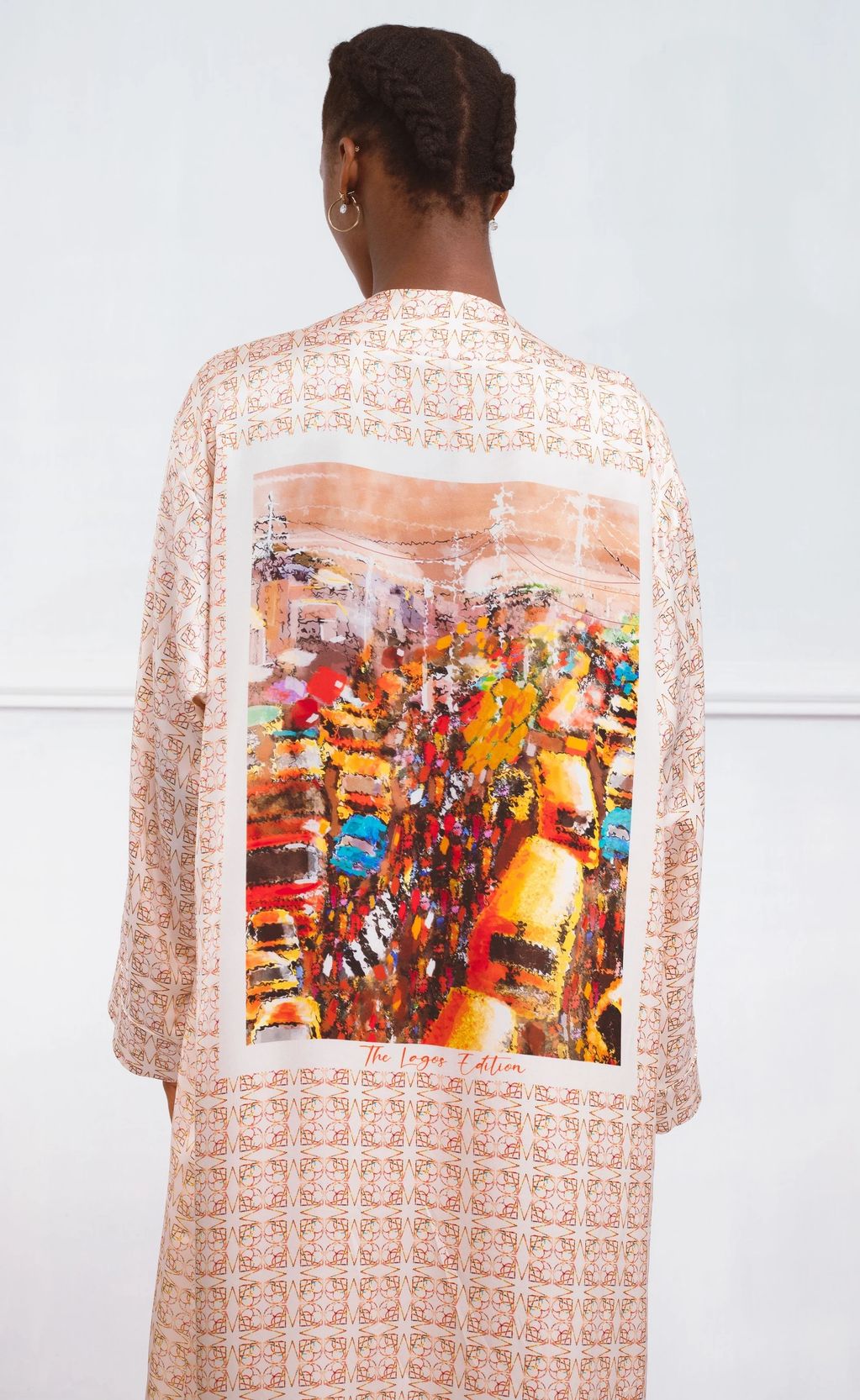 Person wearing a patterned robe with a colorful abstract design on the back.