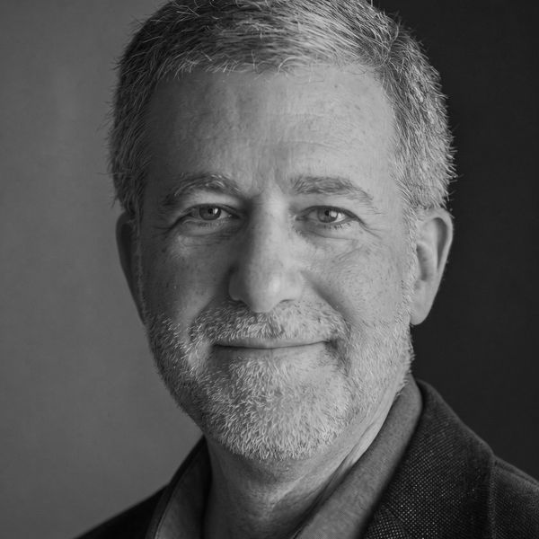 Black and white portrait of a middle-aged man with gray hair and beard.