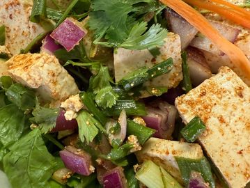 Fresh tofu salad with vegetables and herbs.
