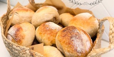 Basket filled with freshly baked rustic bread rolls.