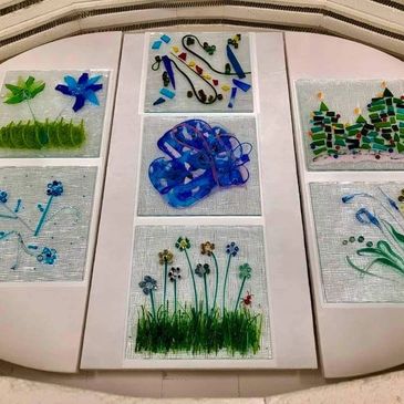 A collection of fused glass squares sitting inside a kiln.