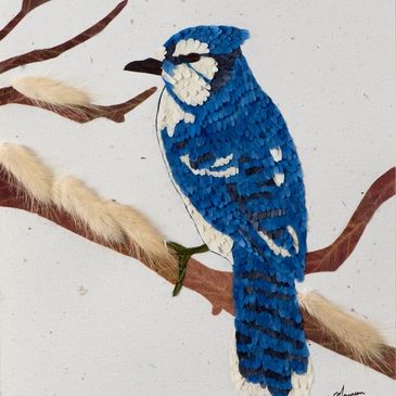 A blue jay made out of pressed flowers.