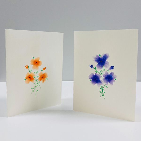 Two card designs featuring watercolor flowers.