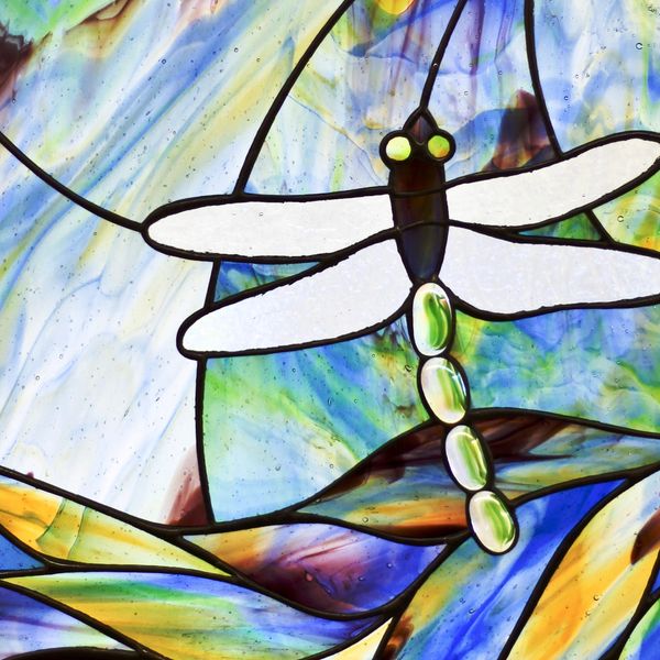 A stained glass piece of a dragonfly.