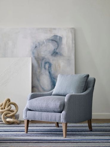 Blue upholstered armchair in a modern room.