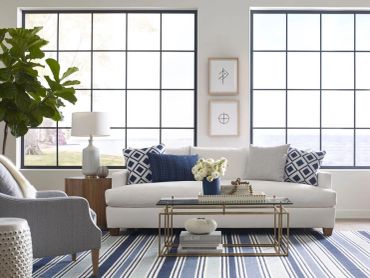 Bright living room with white sofa and blue accents.