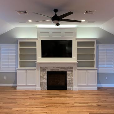 Custom fire place with TV and custom lighting & cabinetry 