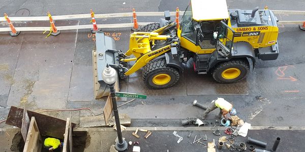Aerial view of a man working beside a vehicle