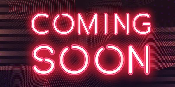 Image showing a neon sign that reads 'Coming Soon'