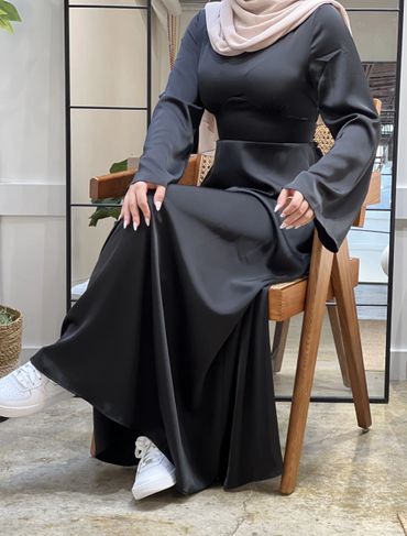 Cinched Satin Black Dress on a model seated view