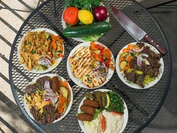 Middle Eastern mezze spread with grilled meats and vegetables.
