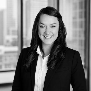 Professional woman in business attire smiling.