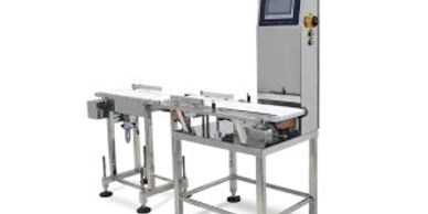 Industrial conveyor system with a control panel for automated processes.