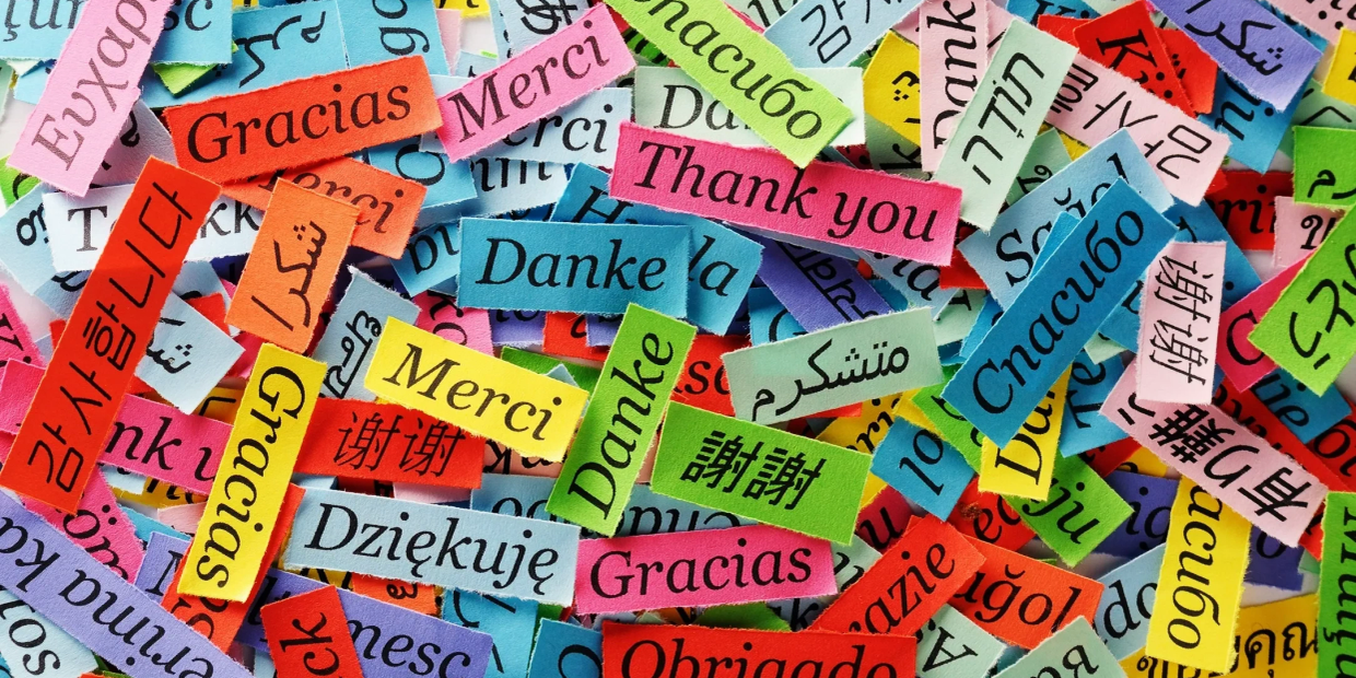 Colorful paper pieces with 'Thank you' written in multiple languages.