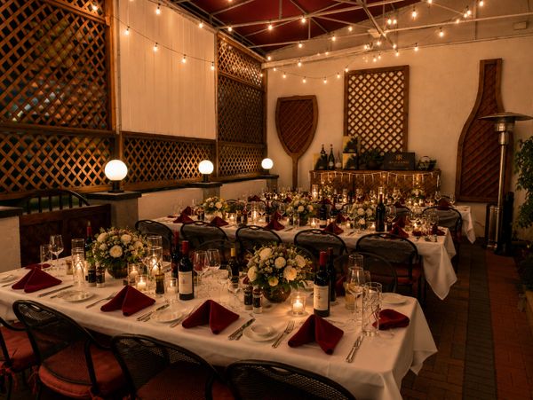 Elegant dining setup with warm lighting and floral centerpieces.