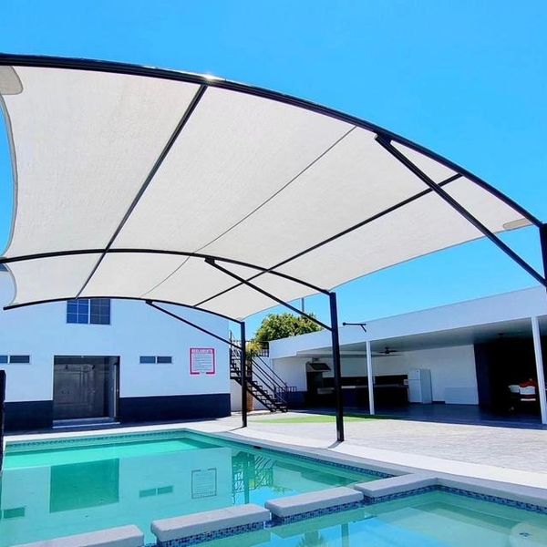 Large backyard Awning hanging over pool