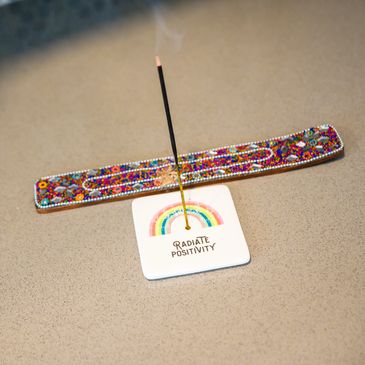 Incense holder on a plate that says "Radiate Positivity" at Yogamazia in Richboro, PA.