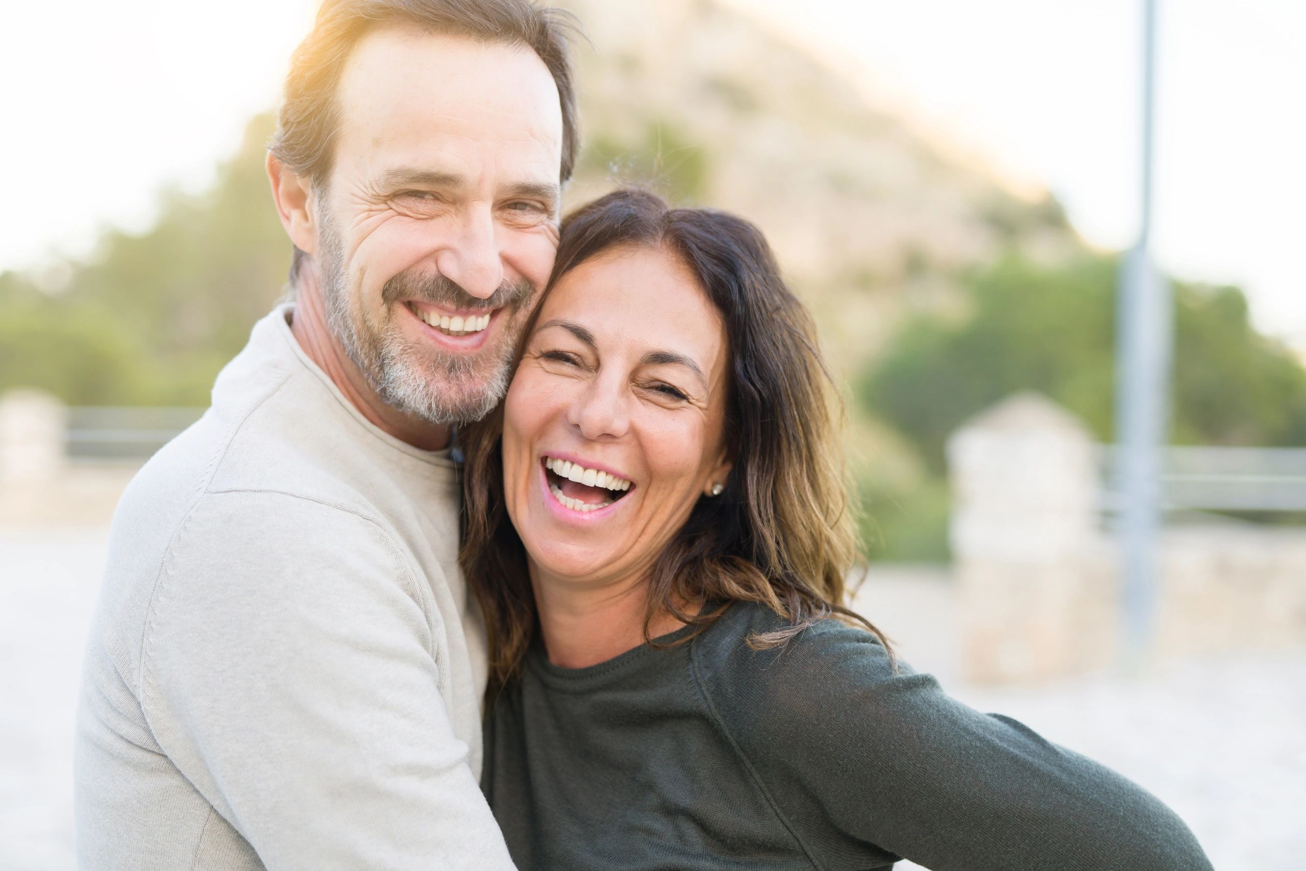 Smiling couple embracing outdoors