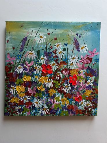 meadow with three bold poppies, pink sweet peas, daisies, and lush green grasses