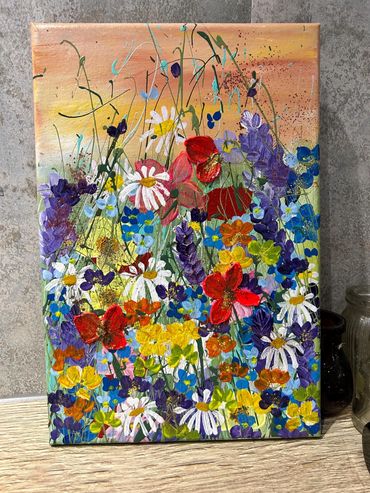 a summer meadow, three poppies, daisies, and springs of lavender dancing in light green grasses. 