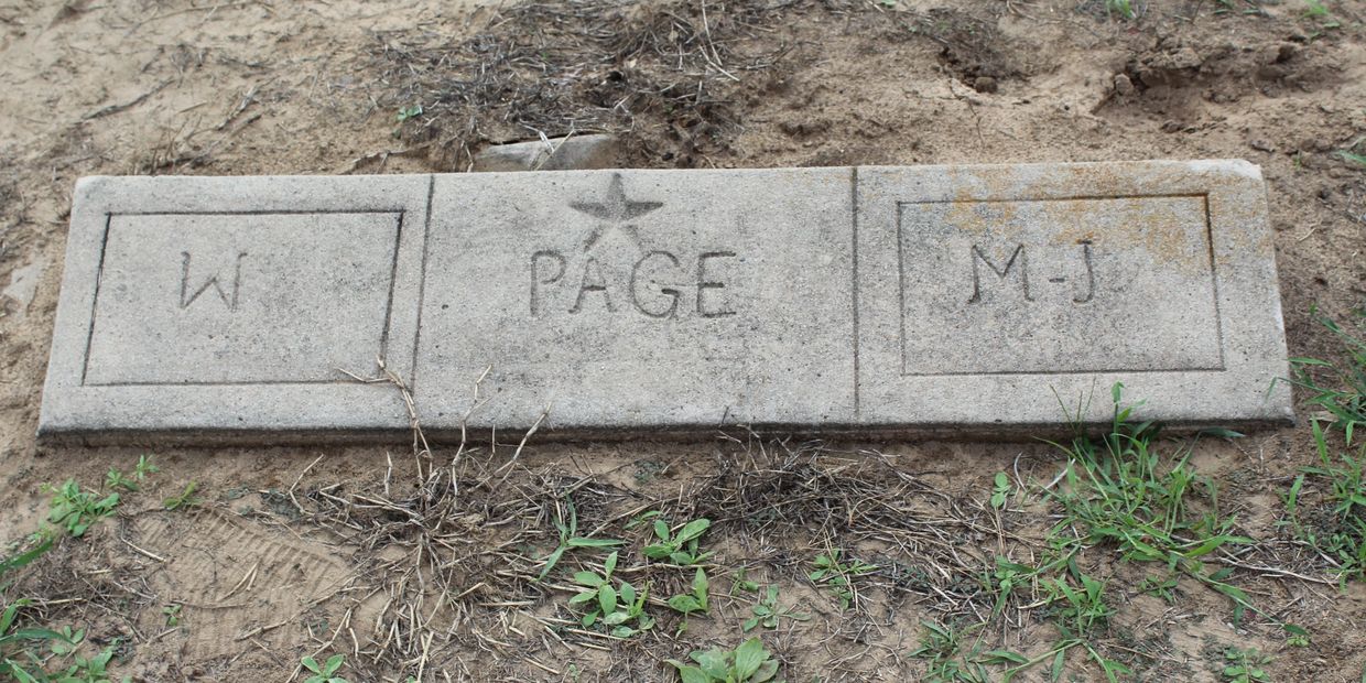 A rectangular stone slab with inscriptions W, PAGE, and M-J.