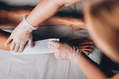 Lower leg wax using strip wax by an esthetician 
