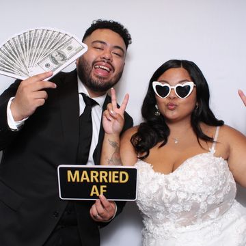 Newlyweds celebrating with playful props and joyful expressions.