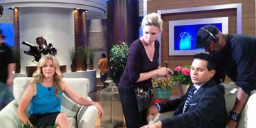 Behind the scenes of a TV show setup with hosts and crew.
